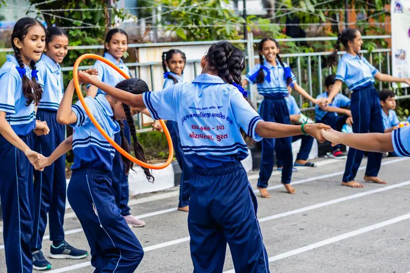 Children playing with hoops on the sports ground