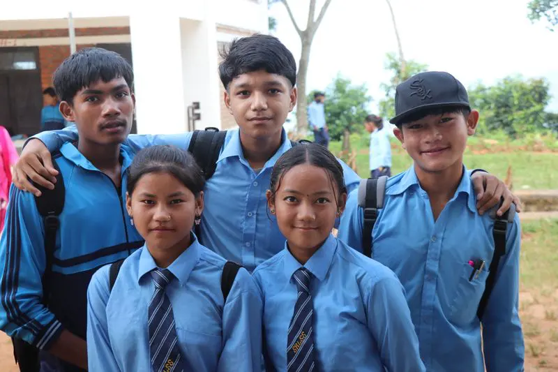 A group of senior students smiling together outdoors
