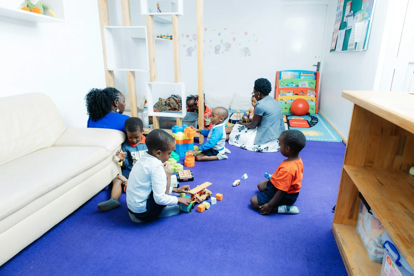 Small children playing together in a bright, modern classroom