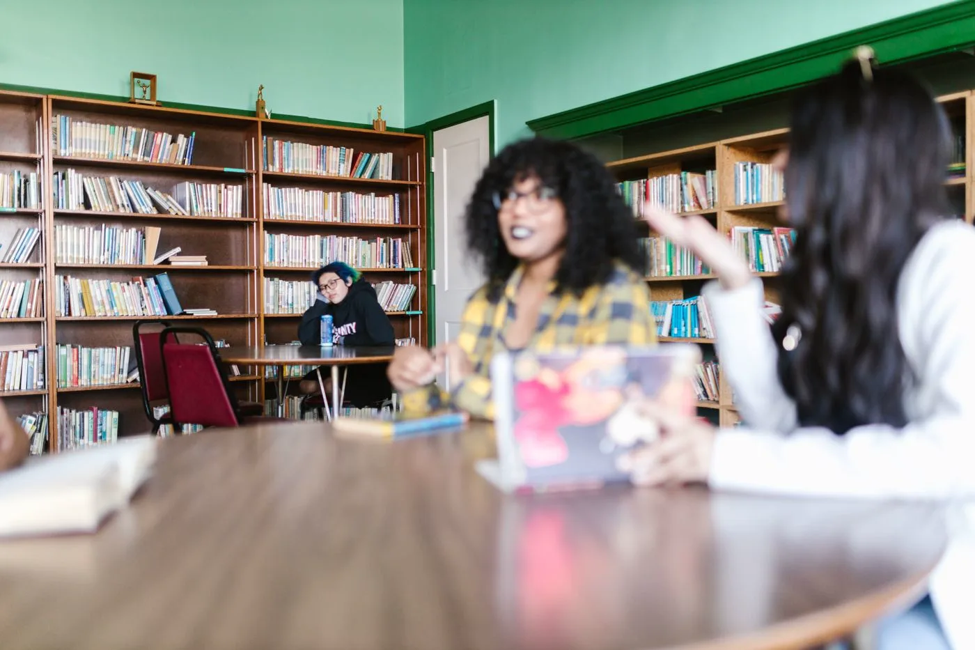 Senior students in discussion around a library table