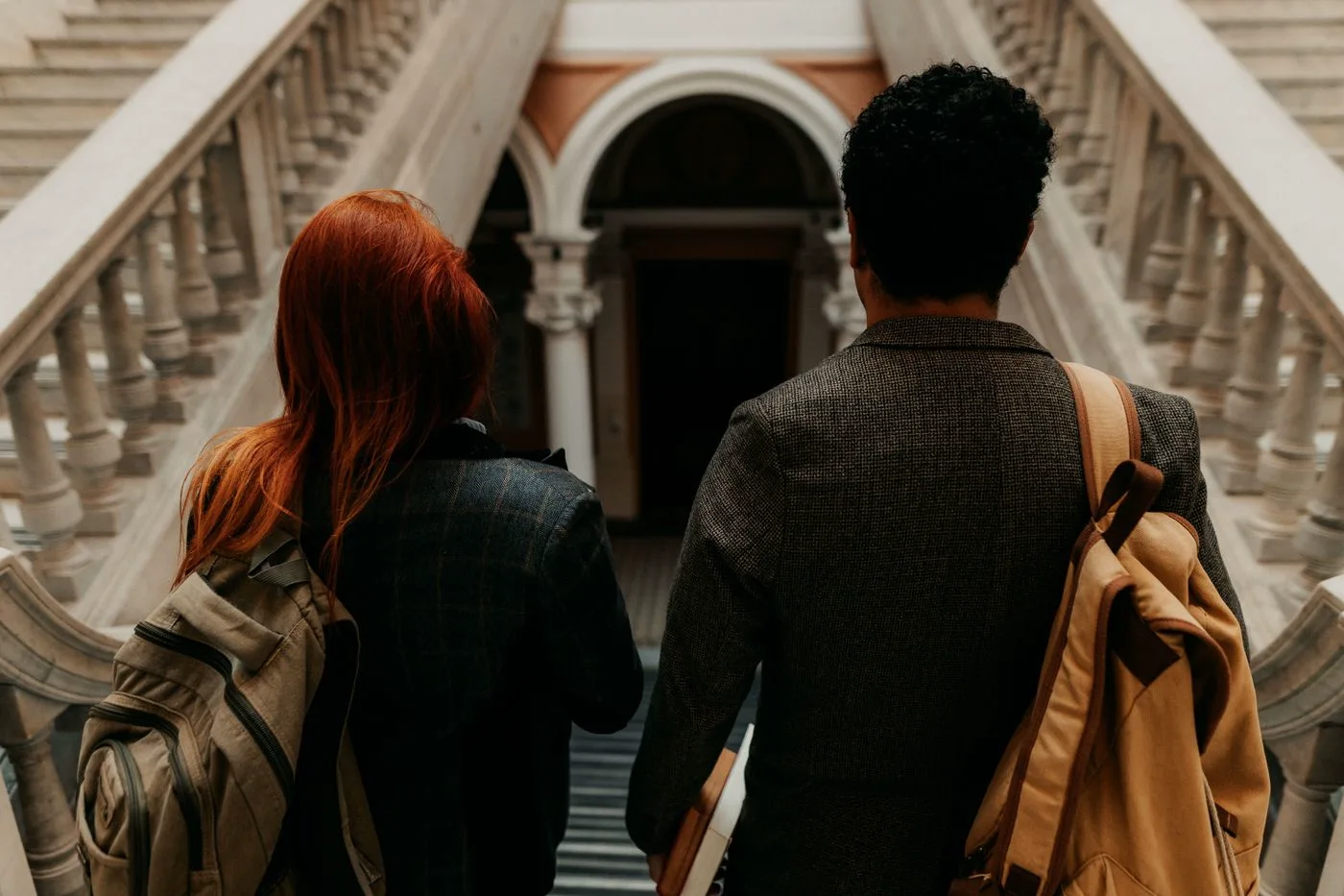 Two senior students walking down the main staircase of the school
